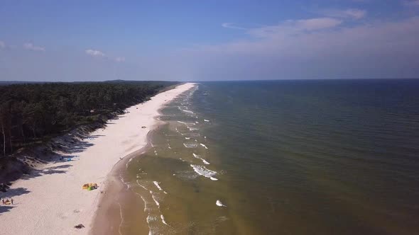 Drone footage of a sandy beach, sunny summer day, Baltic Sea, Poland, Lubiatowo.