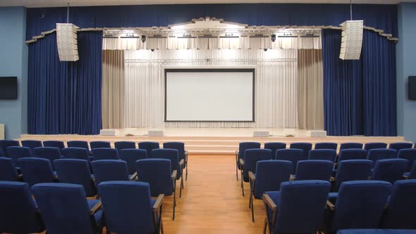 Blank Screen on Stage in Empty Large Conference Hall