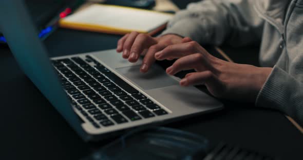 Young Boy Does Homework Scrolls on Laptop Works on Computer Prepares Document School Project Child