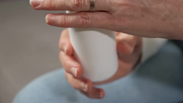 Elderly Woman Takes Vitamins From Package to Maintain Health