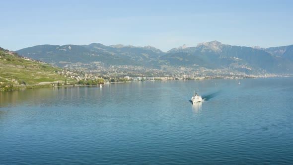 Flying in reverse over Lake Léman with Belle-Epoque steam boat, Vevey, Montreux and the Alps in the