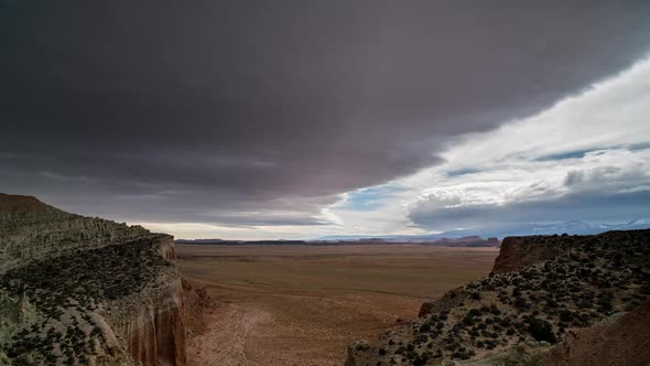 Time lapse of clouds rolling over the Utah desert looking through canyon