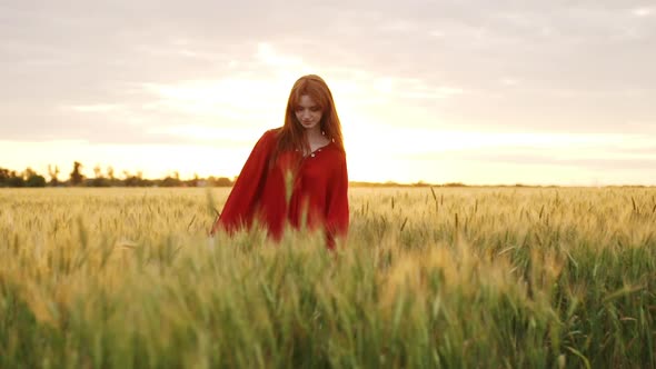 Beautiful Romantic Redhead Girl Dancing on Sunset Evening Sun Appears From Woman Sillhoette Happy