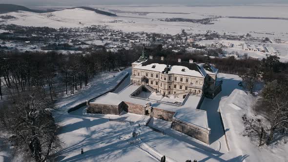 Aerial View Drone Flight Forward Over the Historic Old Castle at Sunny Winter Day Pidhirtsi Palace