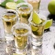 Golden Tequila Shots Served with Lime and Sea Salt on Table - VideoHive Item for Sale