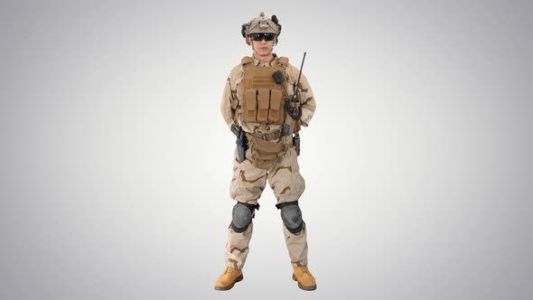 US Military Soldier in Uniform Reports on Gradient Background