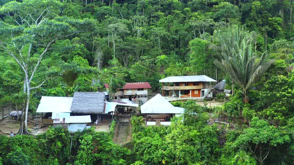 Aerial view of a large lodge, zooming out to show tropical forest