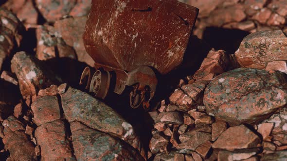 Abandoned Rusty Mine Cart on Rocks alt