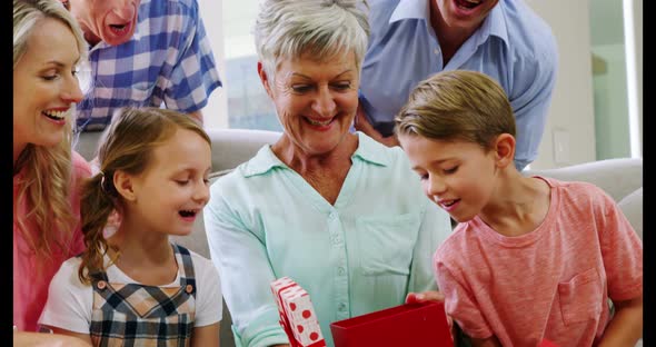 Multi-generation family sitting together in living room