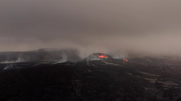 Distant View Of Volcanic Eruption Against Overcast Sky. - Wide Shot