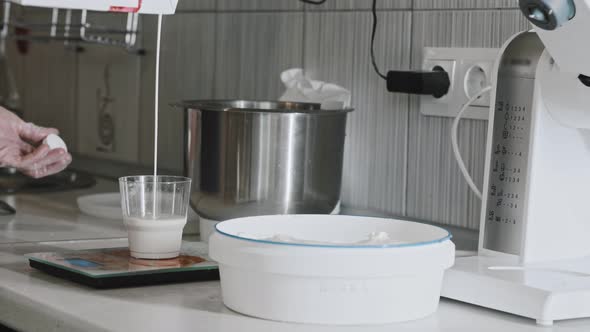 Woman Chef Making Dough  Pouring Milk in the Glass