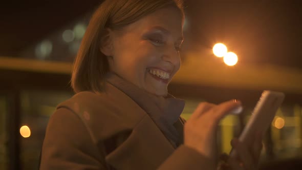 Lady in Her 30s Sincerely Smiling, Reading and Answering Messages From Boyfriend