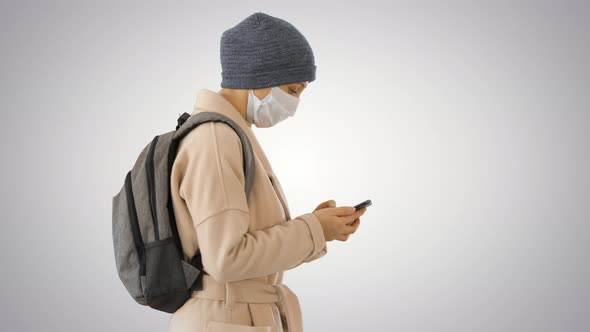 Female Wearing Medical Mask Walking on Gradient Background