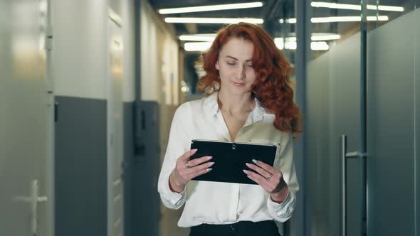 Portrait of a Successful Businesswoman in Glasses and Black Clothes of European Appearance Standing