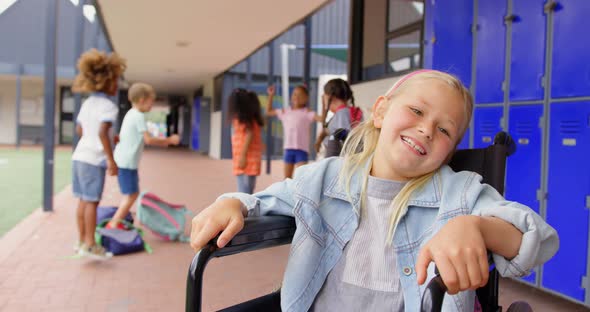 Front view of disabled Caucasian schoolgirl smiling in the corridor 4k