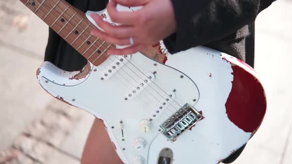 Close Up of Female Hands Playing Vintage Guitar