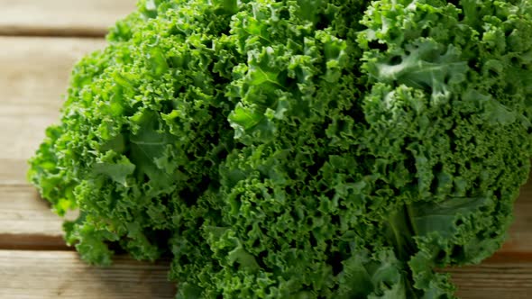 Green leafy vegetable on wooden floor 