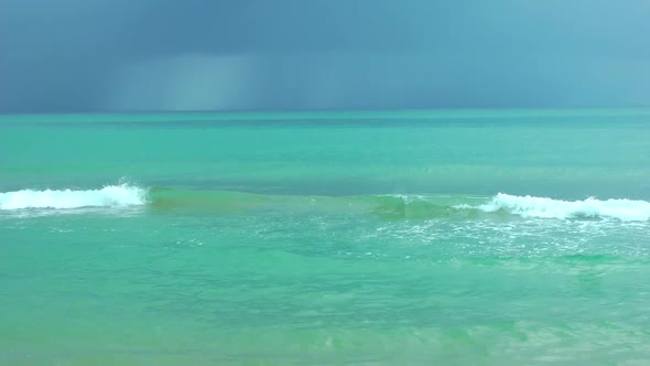 Beautiful Blue Sea with a Wave Before the Rain Dark Clouds in the Sky