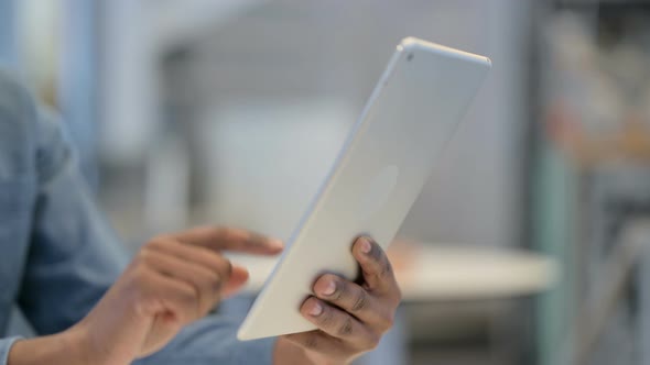 African Man Hands Typing on Tablet Close Up Side View