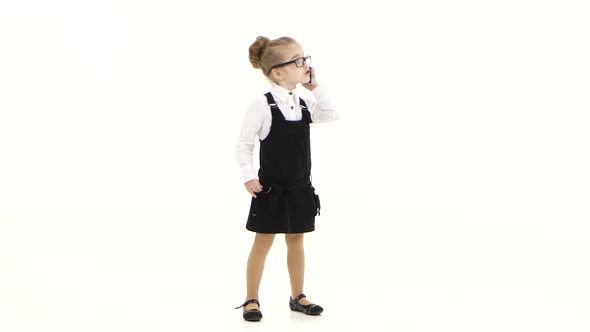 Little Business Girl Communicates By Mobile Phone on White Background