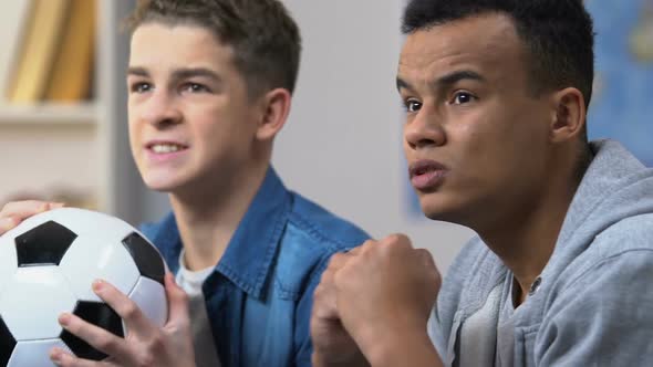 Two Male Friends Upset With Their Favorite Team Losing Soccer Match Fans Closeup