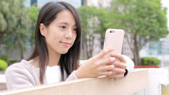 Woman working on mobile phone at outdoor