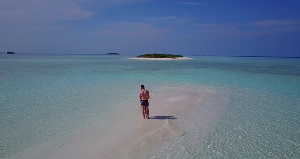 Beautiful man and woman after marriage in love live the dream on beach on clean white sand