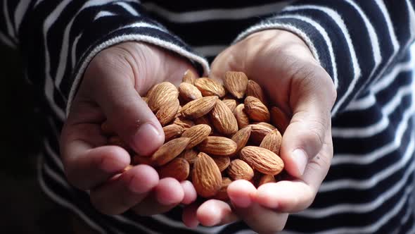 Close Up of Almond Nuts on Man's Hand