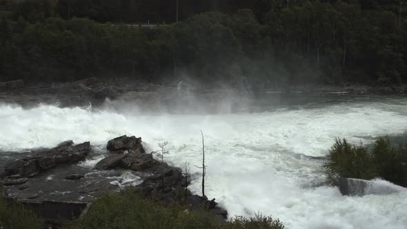 Water Flowing Into River From Hydroelectric Dam