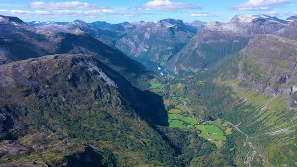 Breath taking view of mountain peaks and green valley and a lake in geiranger fjord in Norway