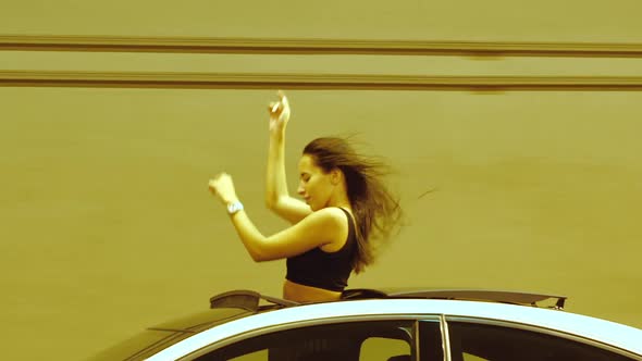 Woman Riding Car in Illuminated Tunnel