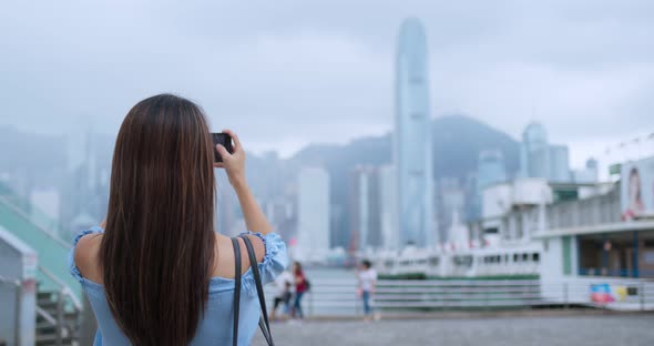 Woman Tourist Take Photo on Cellphone in Hong Kong