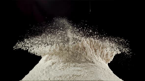 Super Slow Motion in a Pile of Flour on the Table Drops Raw Egg