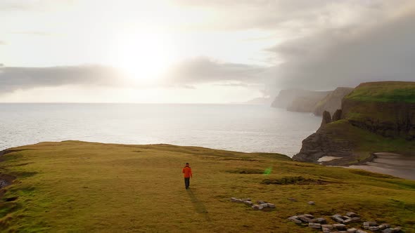 Aerial View of Man Resting After Walking Looking Coast Landscape