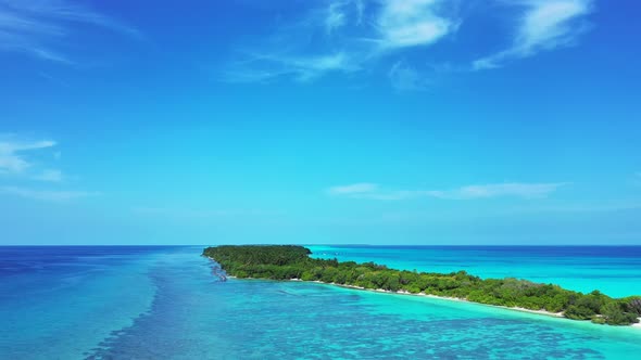 Wide drone copy space shot of a sandy white paradise beach and blue sea background in colourful 