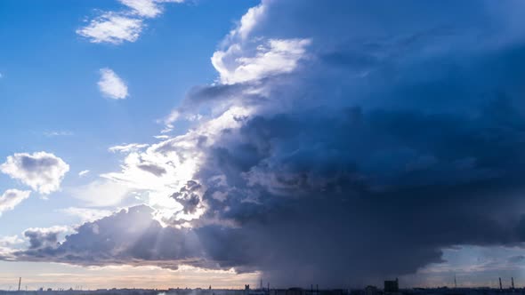 A Huge Storm Cloud with Rain Is Moving Over the City, Timelapse