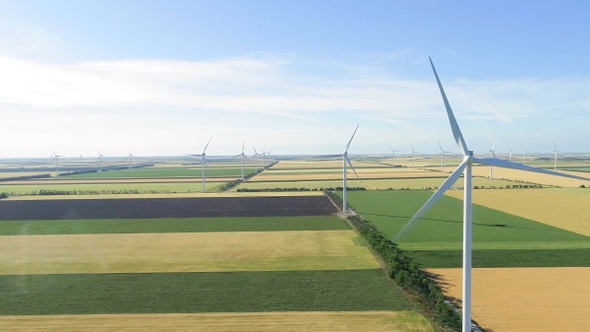 Group of windmills for electric power production in the agricultural fields.