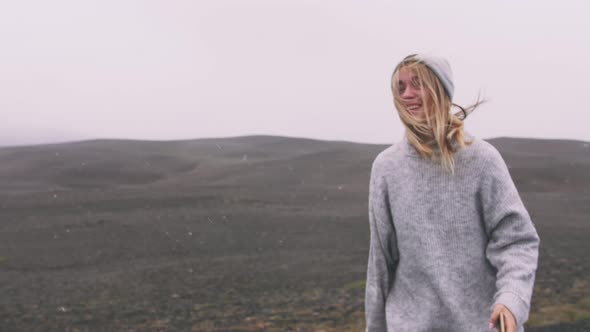 Happy Young Woman Running on Asphalt Road in Iceland and Having Some Fun Enjoying View