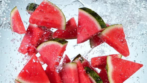 Super Slow Motion Shot of Flying Fresh Melon Cuts and Water Side Splash at 1000 Fps