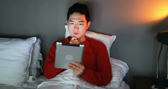 Man using digital tablet on bed 4k