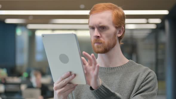 Portrait of Attractive Young Man Using Tablet in Office