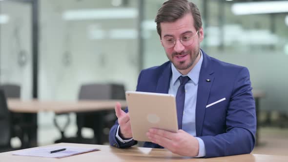 Professional Young Businessman Doing Video Call on Tablet