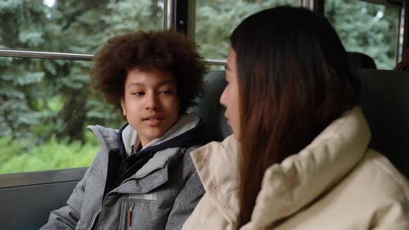 Multiethnic Pupils Talking While Riding School Bus