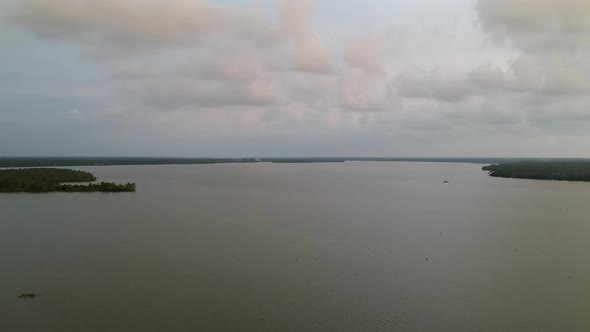 Beautiful aerial shot of a backwater Vembanadu Lake,water lines,twilight sunset,coconut trees ,water