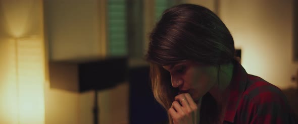 Close up of a young female student studying at home in the evening