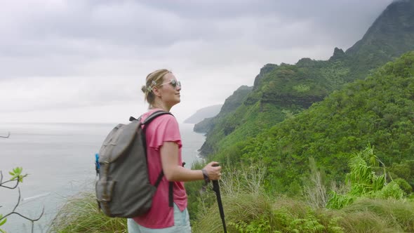 Slow Motion Woman Walking By Green Jungle Mountain on Cloudy Coast Background