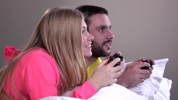 Young Couple in Bright Pajamas, Pillow Fight, Slowmotion