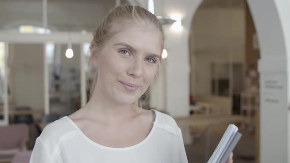 Happy Beautiful Fair Haired Young Woman Holding Documents