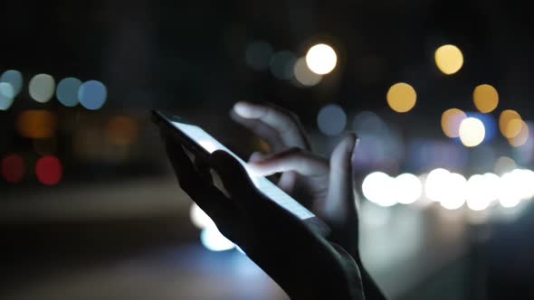 Women Using Cellphone At Night