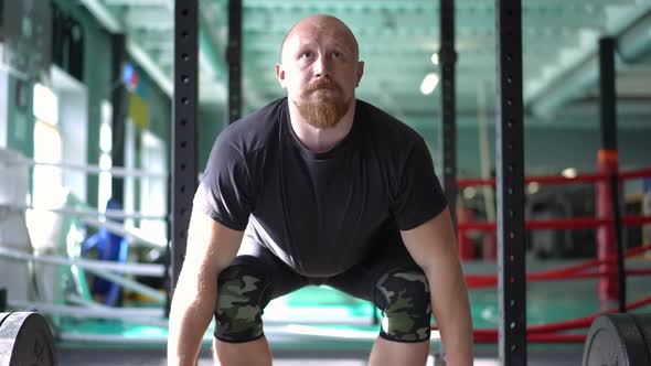 Live Camera Follows Lifting of Barbell By Strong Muscular Caucasian Male Bodybuilder in Gym